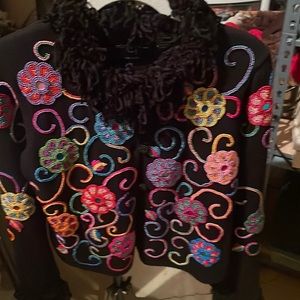 Black sweater with many details of beads. Michael Simon